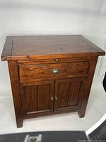 Side view of solid wood side entry table with dovetail drawer and cast-iron hardware