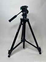 Full view of black Velbon Challenger 455 tripod showing extendable legs and pan tilt head with handle.