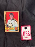 Photo showing front of 1972-73 O-Pee-Chee Phil Esposito hockey card with auction tag number 058.