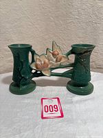 Front view of Roseville Pottery double bud vase showing green ceramic and floral design with water lilies.