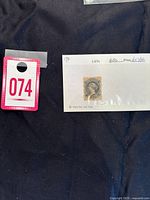 Photo of 1860 Nova Scotia 1 cent Queen Victoria stamp mounted on paper with price and catalog info visible.