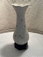 Full front view of 10.5 inch white porcelain vase with scalloped rim and shamrock design
