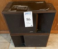 Pair of Bose 201 Series II loudspeakers stacked, showing front black grilles and wood grain finish.