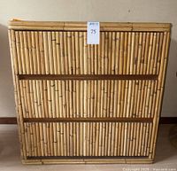 Front view showing the three bamboo drawer fronts and overall bamboo construction with some blemishes.