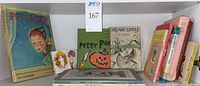 Photo of entire book lot showing titles including Peter Pan, Stuart Little, and several other vintage children's books arranged on a shelf