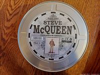 Photo of the metal movie reel style tin packaging with Steve McQueen and Movie Icons branding