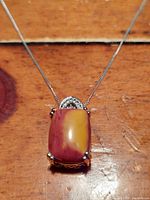 Front view of the Mookaite gemstone pendant with visible raspberry and honey colors on a sterling silver chain.