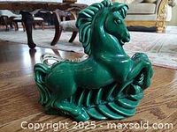 Green pottery table lamp shaped like a rearing stallion horse.