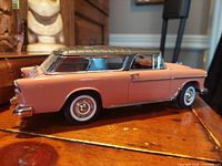 Side view of the 1955 Chevy Nomad diecast model showing the grey coral body and detailed chrome trim.