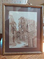 Framed watercolour painting showing street scene in Jerusalem under glass in oakwood frame