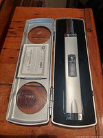 Silver Zippo multi purpose butane lighter in open protective case with certificate inside lid.