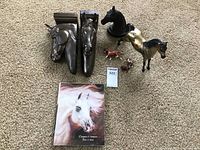 Full lot view showing all items including two horse head sconces, horse figurines, and the horse poster