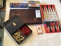 Overview of lot showing Scrabble box, dominoes, chess set, playing cards, backgammon board, and checkers pieces.