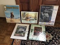 Five horse-themed posters and prints arranged on a wooden floor and carpet showing variety of Morgan horse art and exposition posters.
