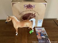 Photo showing the model horse in front of its original box and pamphlet for scale and authenticity.