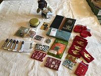 Collection of Starbucks-themed coffee memorabilia including a Seattle Bearista bear plush, coffee cup sleeves, patches, pins, cards, and other coffee-related small items arranged on a table