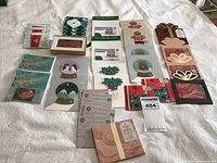 Full overview of all Starbucks gift cards laid out on white fabric showing variety of holiday and themed designs in sets and individual cards.