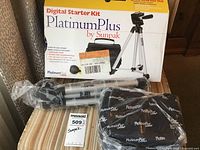 Full kit with box, tripod, and carrying case wrapped in protective plastic