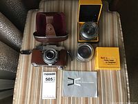 Kodak Retina Reflex Camera with attached brown leather case, Kodak Retina Longar lens components in original boxes, Kodak Retina Reflex Camera manual, Kodak Extralite 500 camera.