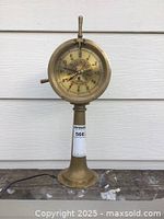 Front view of telegraph showing brass case, pedestal and top lever