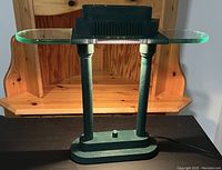 Robert Sonneman bankers desk lamp showing its overall design, base, columns, and glass shade