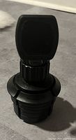 Front view of the black car phone holder showing the magnetic phone mount and cup holder base