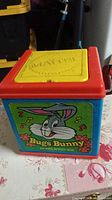 Front view of a Bugs Bunny music box featuring colorful plastic casing and character graphics
