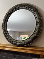 Front view of 31 inch round mirror showing entire ornate frame and reflective surface.