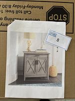 Photo of box with printed image of the desk attached, showing product design and style.