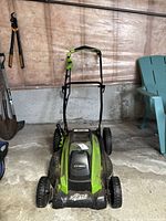 Front view of Greenworks Digipro electric lawn mower with handle and wheels visible