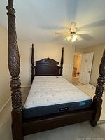 Assembled bed frame with mattress in bedroom
