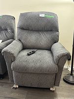 Front view of grey Franklin power lift chair showing remote control