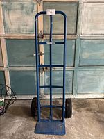 Front view of the 51-inch tall blue moving dolly showing its rectangular base and two solid wheels.