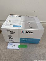 Box labeled Moen Zarina 82533 with brand and model details visible
