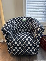 Front view of tub-style accent chair with navy and white geometric patterned upholstery, showing the overall shape and fabric design.
