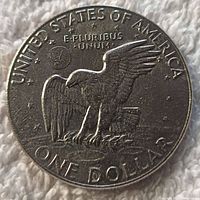 Obverse side of 1977 one dollar Eisenhower coin showing eagle design and inscriptions
