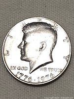Obverse side of a 1776-1976 Kennedy Bicentennial half dollar coin featuring John F. Kennedy profile with inscriptions.