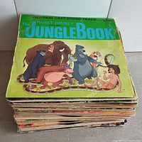 Stack of Disney vinyl record albums with The Jungle Book cover visible on top, showing colorful artwork and characters from the movie.