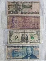 Four currency bills: 1981 Mexico 500 Pesos, 100 Pesos, US one dollar bill, and 50 Pesos arranged vertically on a white surface.