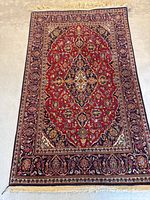 Full view of the vintage Kashan rug showing overall condition, size, and fringe detail.
