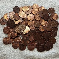 Photo of mixed USA and Canadian pennies showing a variety of dates and conditions.