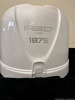 Front view of the white plastic hair dryer hood with branding 'RED by KISS 1875'