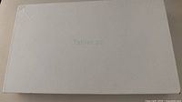 Closed white box labeled 'Tablet pc' shows lot packaging.