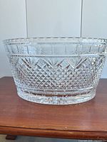 Side view of vintage crystal tub showing diamond cut pattern and polished rim.