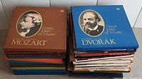 Two stacks of classical vinyl records box sets with large portrait covers of composers Mozart and Dvorak.