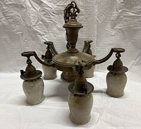 Five-arm brass fixture with all five shades arranged around central hub seen front-on