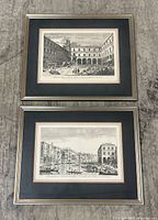 Overview of both framed etchings on floor