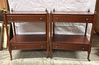 Front view of both side tables showing pair with top drawers and middle shelves