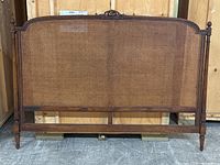 Full front view of king size headboard showing carved frame and cane panel