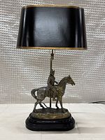 Full view of lamp with black shade, bronze-tone Napoleon sculpture on wooden base